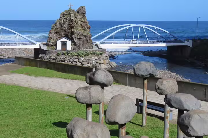 Scenic view of a coastal bridge and rock formations in Northeast Madeira, ideal for a full-day guided tour experience.