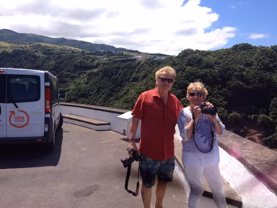 Travelers with cameras beside tour van at panoramic mountain viewpoint on Northeast Scenic Tour full-day van trip