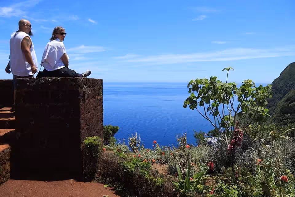 Visitors enjoy dramatic cliff-top viewpoint on Northeast van scenic tour, full-day settlement excursion by sea