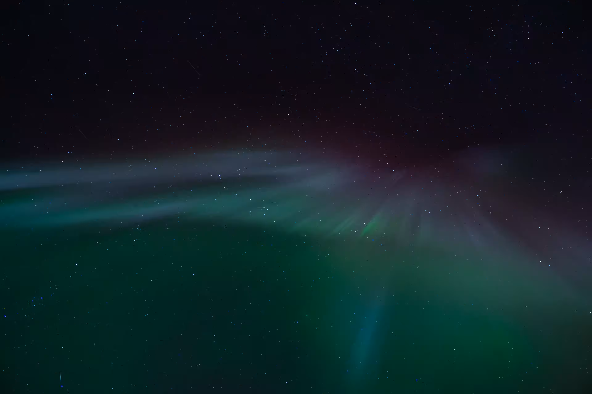Green aurora borealis glowing under a star-filled Arctic sky, perfect for a Northern Lights tour night