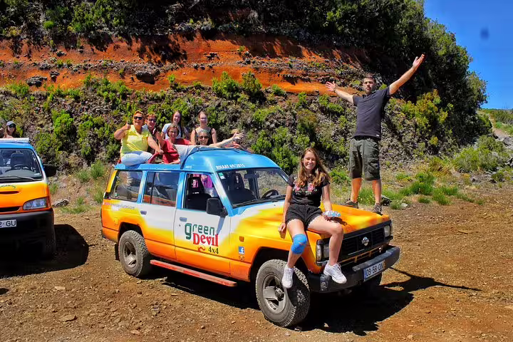 Group of tourists enjoying a 4x4 adventure tour at Northwest Terraces, exploring volcanic pools and stunning landscapes.