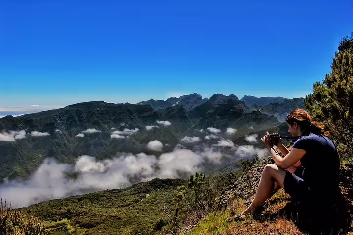 Woman captures stunning views of lush mountain terraces and clouds during a 4x4 tour of volcanic pools in the northwest.