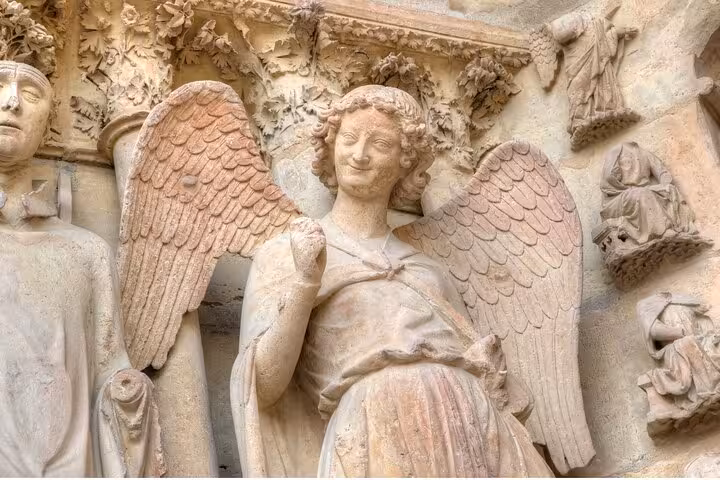 Close-up angel sculpture on Notre-Dame Cathedral, seen on Paris half-day private guided tour with Seine cruise
