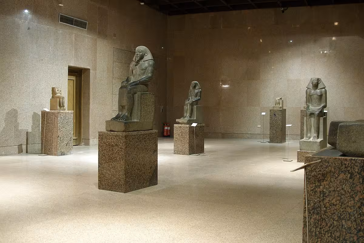 Inside Nubian Museum Aswan gallery with ancient Egyptian statues on pedestals, guided museum tour highlight