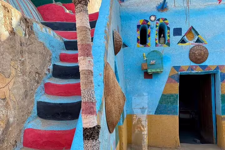 Bright blue Nubian Village house with painted stairs and traditional decor on Aswan motorboat private tour with guide