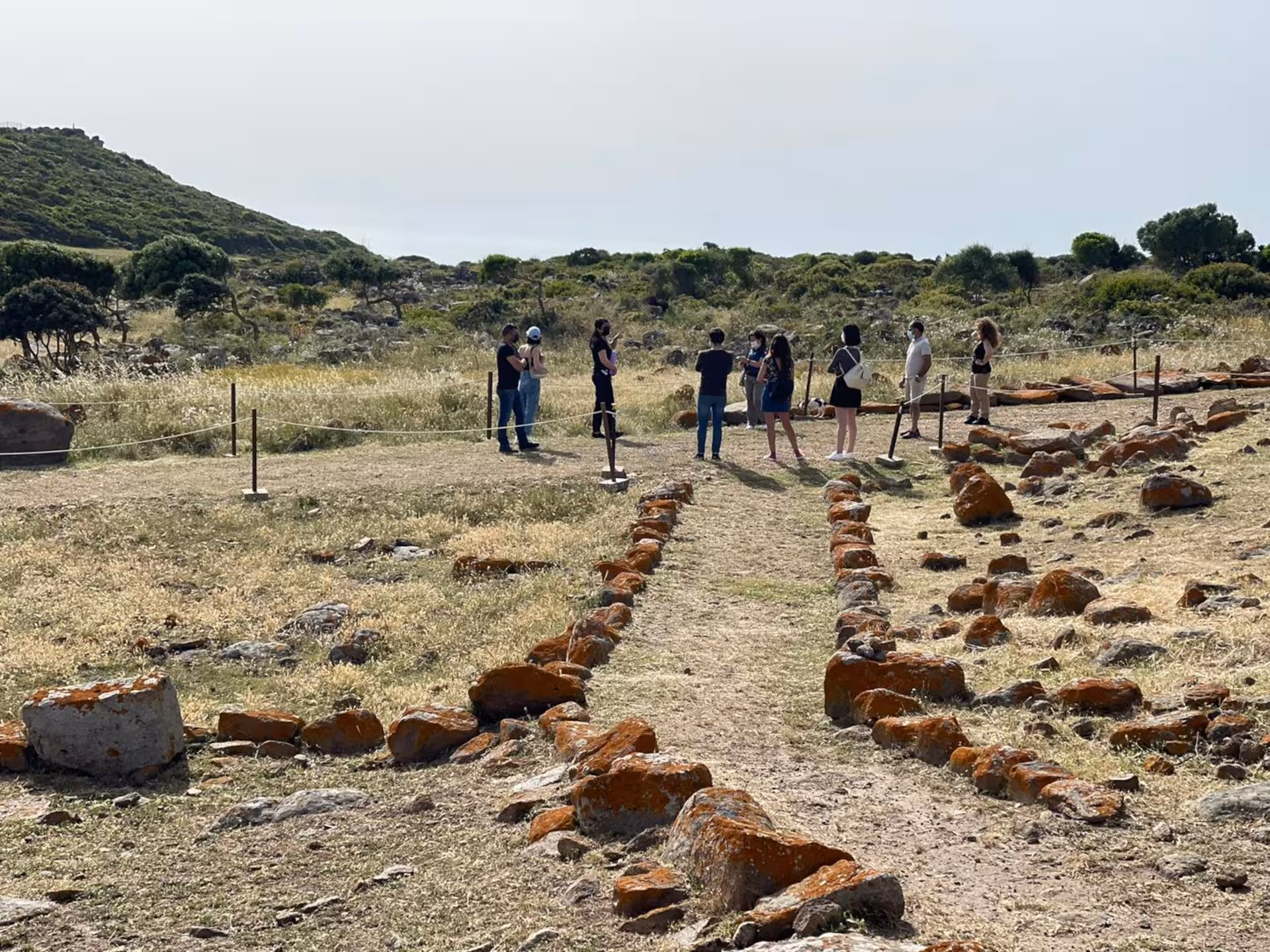 Visitors at Nuraghe Seruci in Gonnesa enjoy guided tours among ancient stone paths and lush Sardinian landscapes.