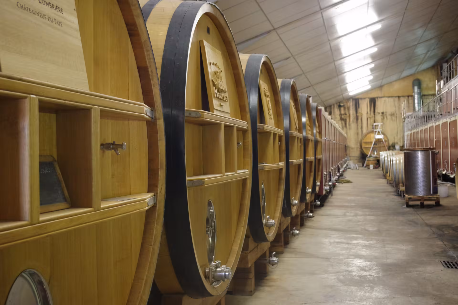 Oak wine barrels in a Provence winery cellar on the Coteaux d'Aix-en-Provence and Sainte-Victoire tour