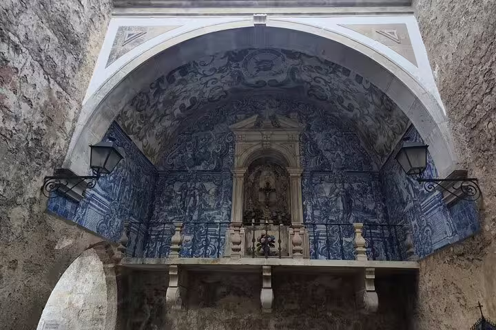 Intricate blue azulejos adorn a historic archway in Óbidos, highlighting Portugal's rich architectural heritage.