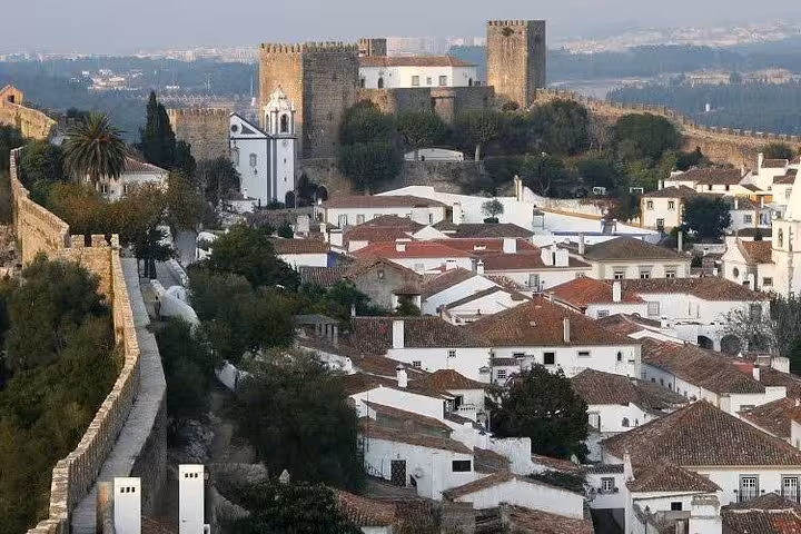 Obidos medieval castle and whitewashed rooftops, scenic stop on Lisbon to Porto private transfer tour