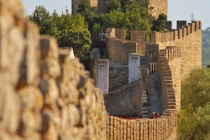 Ancient stone walls of Óbidos Castle on a sunny day, a highlight of the Fátima, Nazaré, and Óbidos full-day tour.
