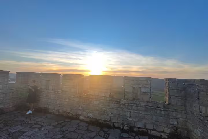 Experience the breathtaking sunset from the stone walls of Óbidos Castle, offering panoramic views of the horizon.