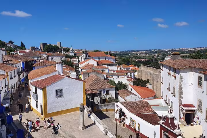 Charming view of Óbidos with its historic whitewashed buildings and cobblestone streets, a highlight of the Fátima, Nazaré, Batalha & Óbidos tour.