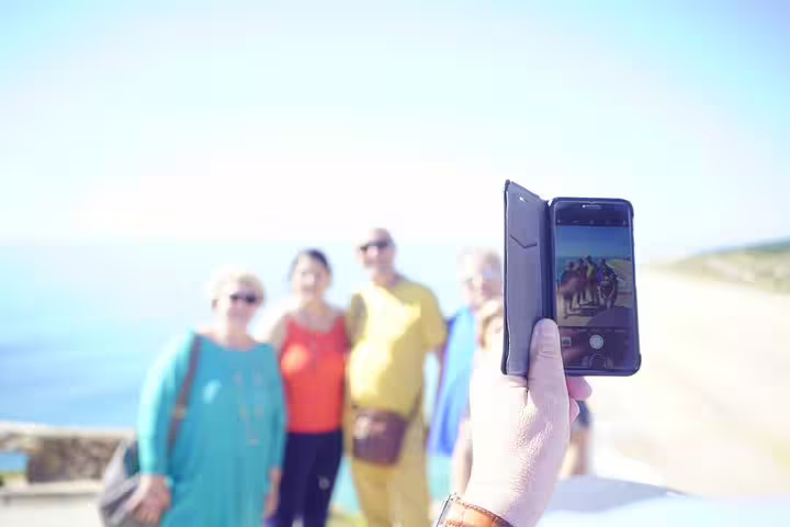 Tourists capturing memories on the scenic Óbidos, Nazaré, Alcobaça, Batalha, and Fátima private tour from Lisbon.