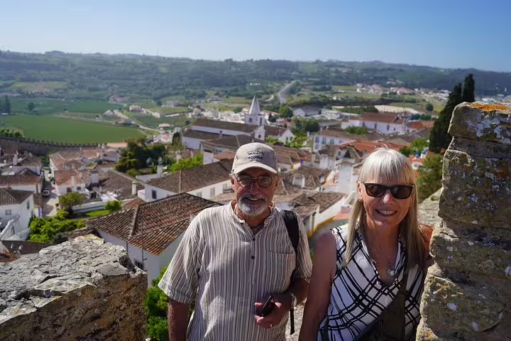 Tourists enjoying panoramic views of Óbidos during a full-day private tour from Lisbon, exploring historic Portuguese towns.