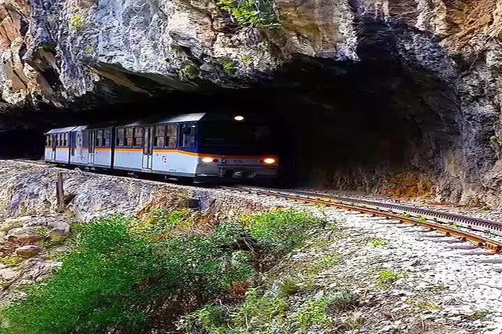 Odontotos rack railway train entering a rocky tunnel near Kalavryta on the Cave of Lakes day tour