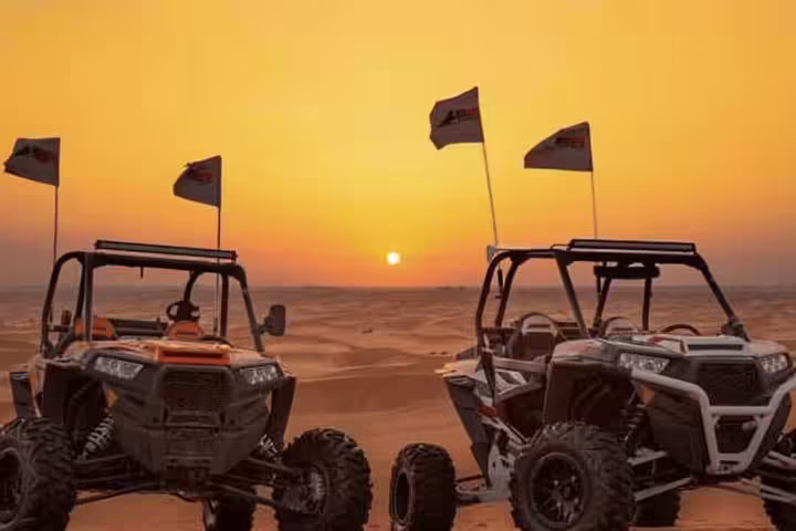Two off-road buggies in a stunning desert landscape at sunset, perfect for an adventurous self-drive buggy and bike tour experience.