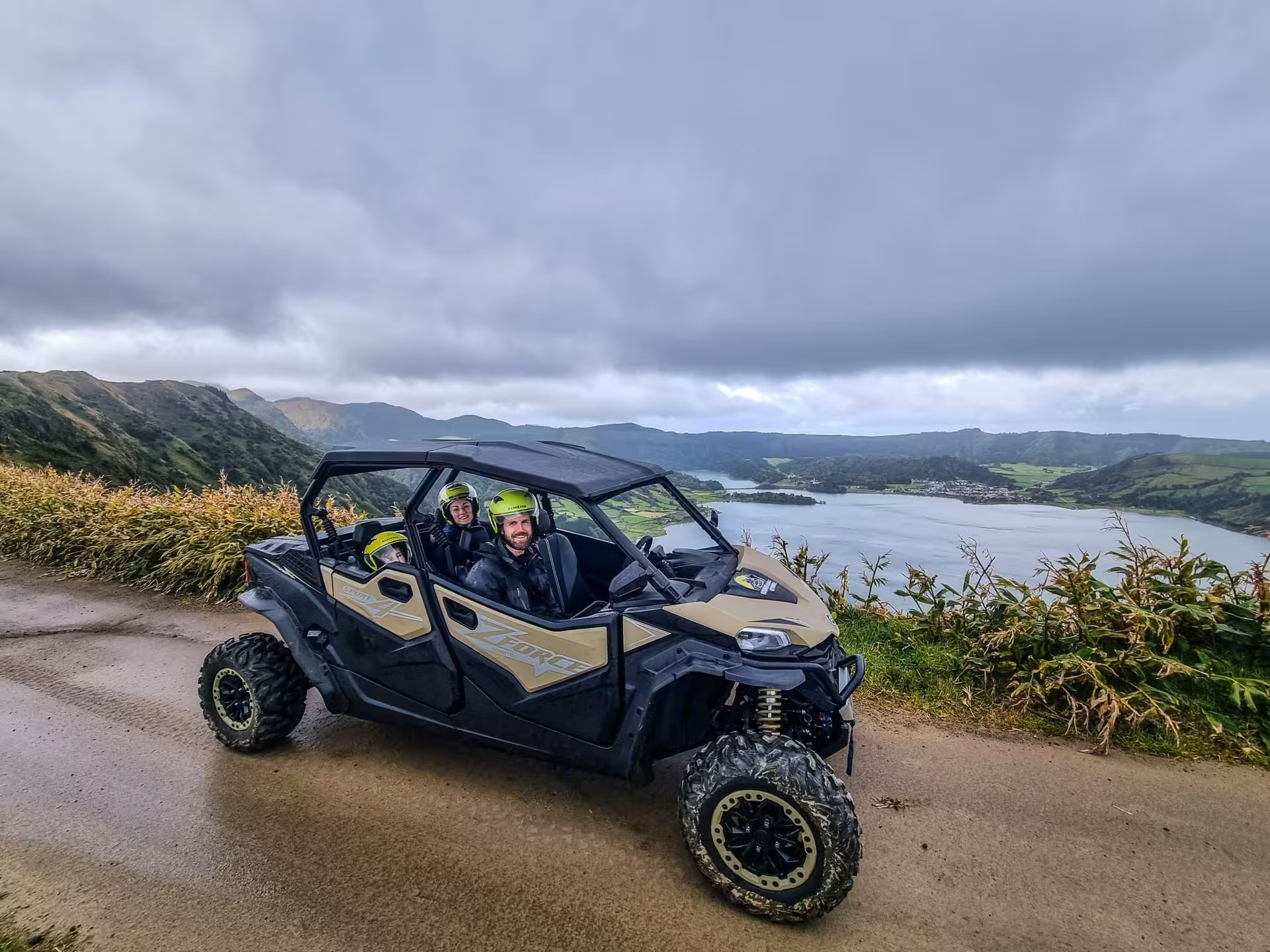 Off-road buggy with helmeted riders at Sete Cidades viewpoint, São Miguel Azores half-day tour