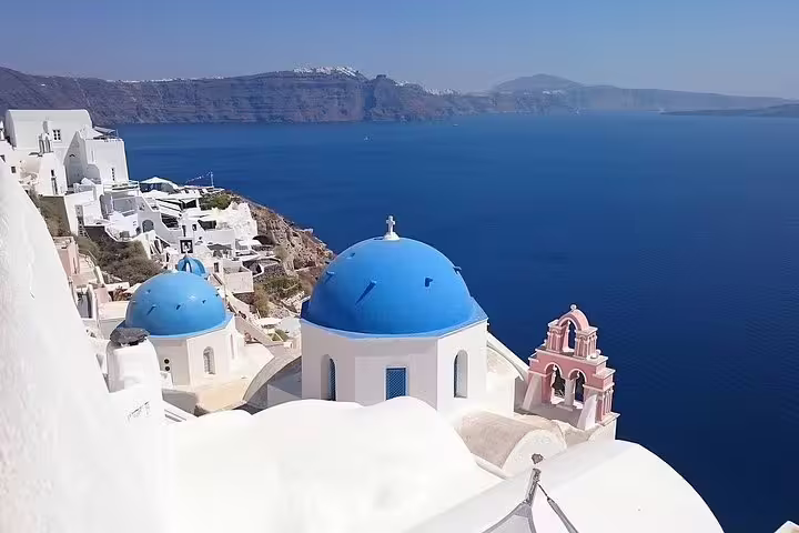 Oia Santorini blue-domed churches and caldera sea view on a private 2-hour sightseeing tour