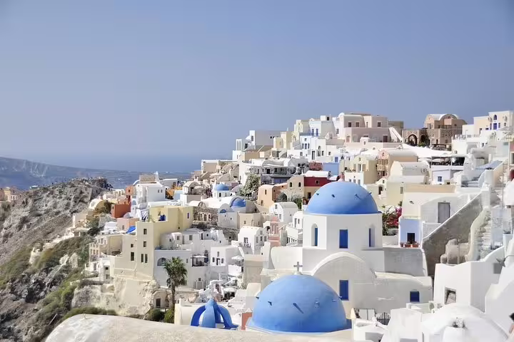 Oia Santorini blue-domed churches and whitewashed cliffside houses on a private 2-hour sightseeing tour