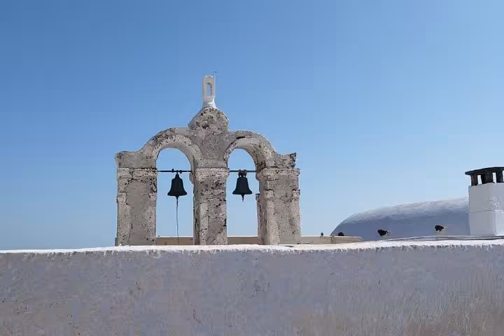 Oia Santorini church bell tower above whitewashed rooftops on a cruise shore excursion walking tour
