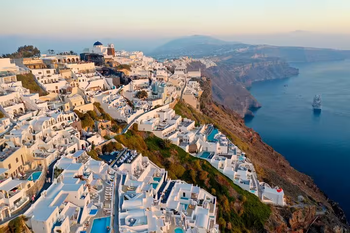 Aerial view of Oia, Santorini cliffside whitewashed houses and caldera on an exclusive small group tour