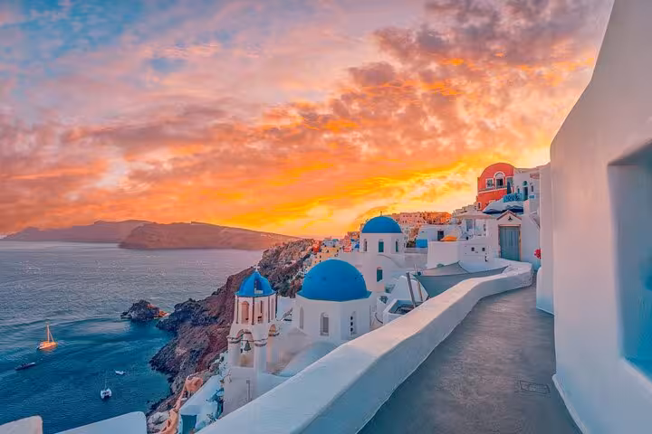 Oia sunset viewpoint with blue-domed churches and caldera views on a private half-day Santorini tour