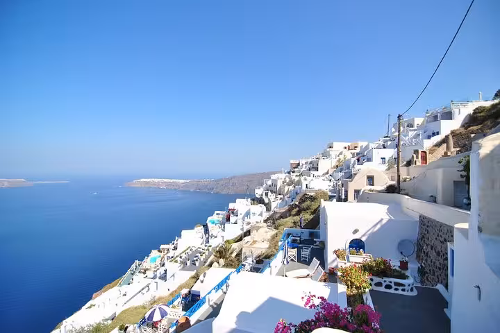 Oia village caldera view with whitewashed houses and blue sea on a private half-day Santorini tour
