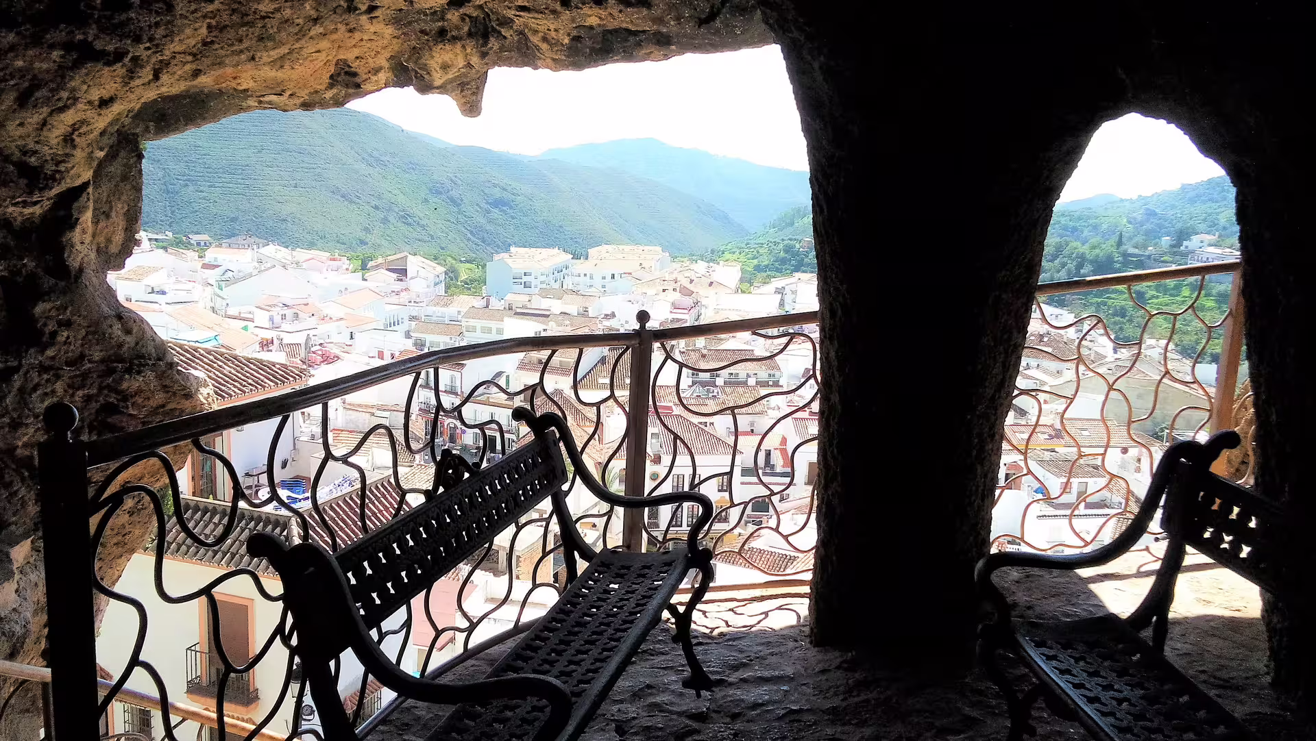 View from Ojen cave balcony over white village rooftops and Sierra Blanca on private tour from Costa del Sol