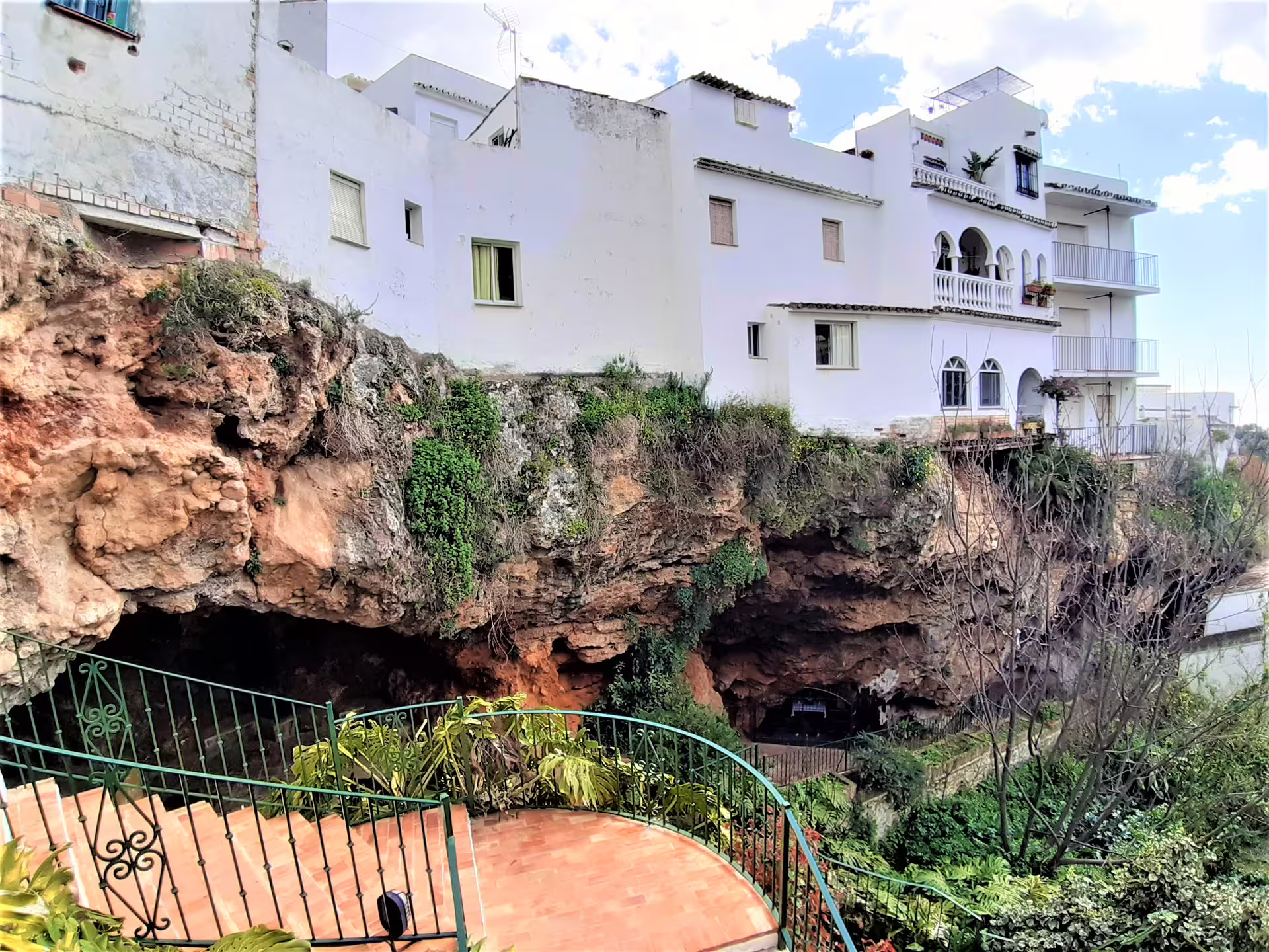 Whitewashed Ojen houses perched above caves, seen on an Ojen private tour from Costa del Sol, Spain