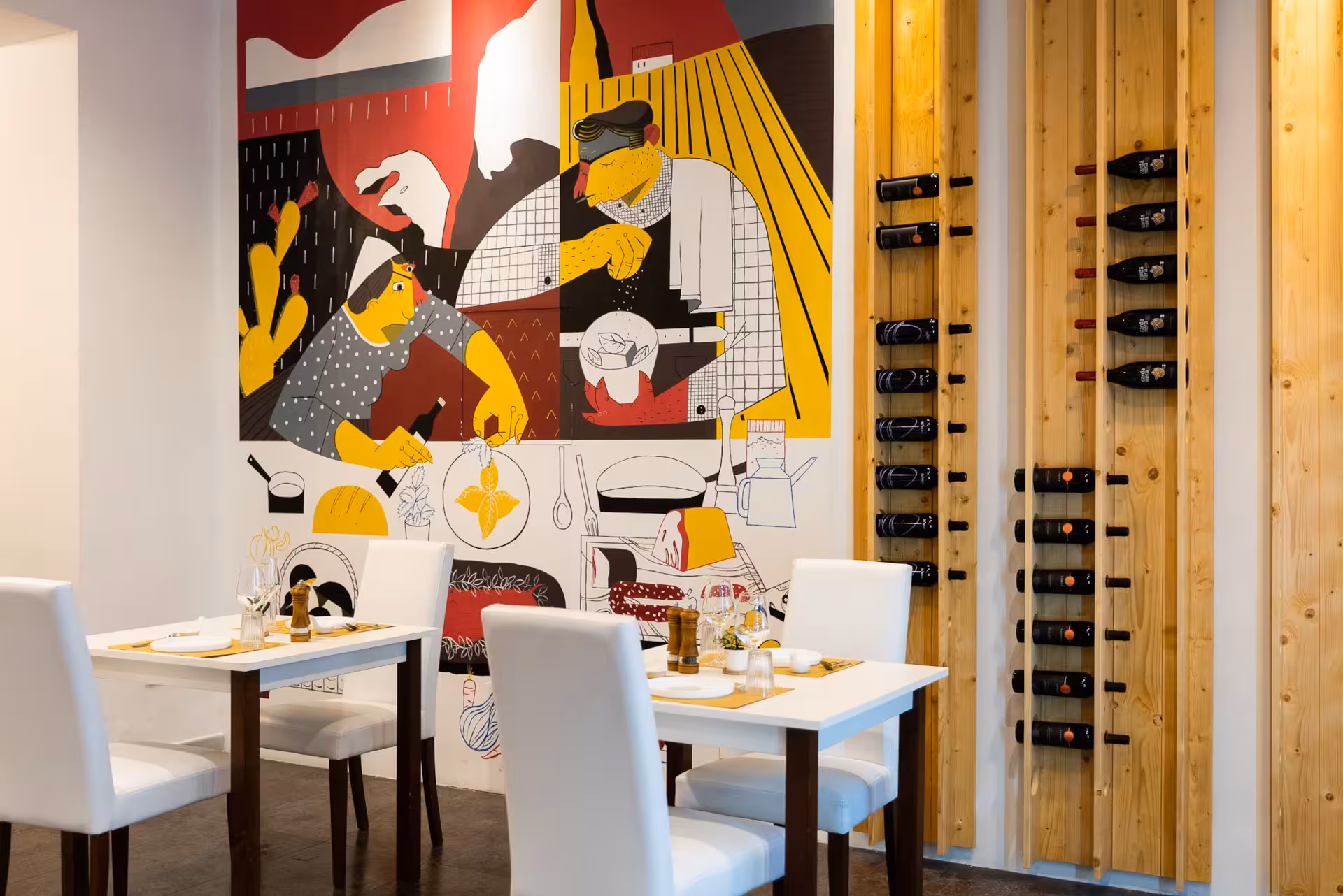 Contemporary Sardinian tapas restaurant in Olbia with vibrant wall art and a stylish wine display.
