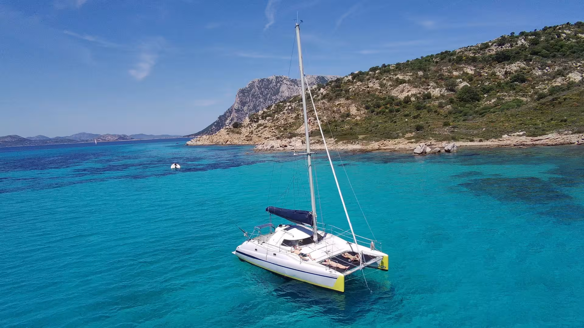 Discover crystal-clear turquoise waters and rugged coastlines on an Olbia catamaran tour, perfect for relaxation and exploration.