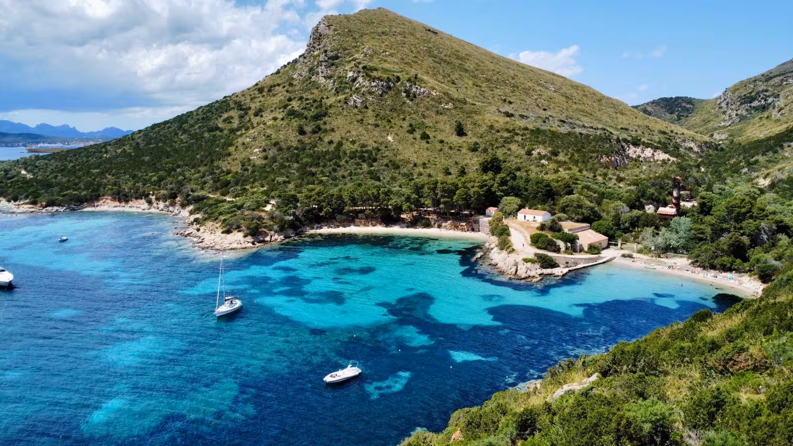 Scenic view of turquoise waters and lush hills on the Tavolara and Cala Moresca sailing tour.
