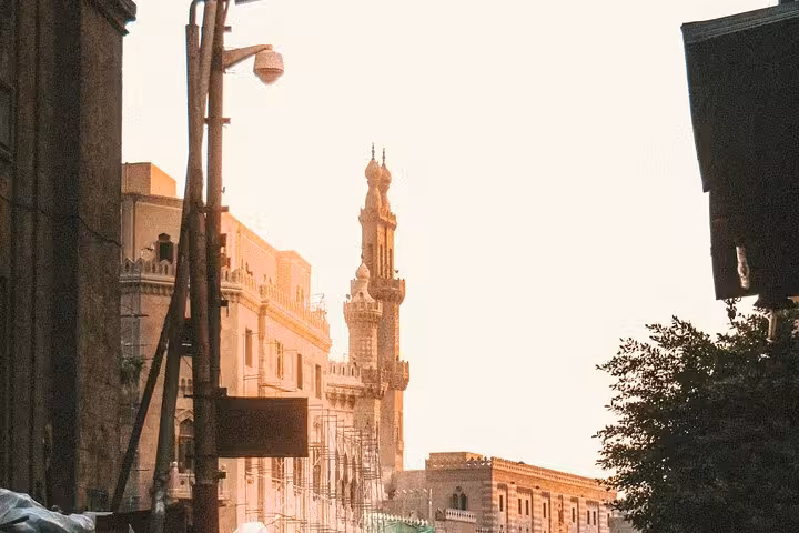 Sunset view of a medieval Cairo street with historic mosque minaret on an Islamic heritage walking tour