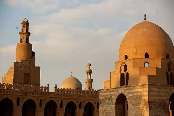 Sunlit mosque domes and minarets in Medieval Cairo old city, Islamic heritage tour architecture highlights
