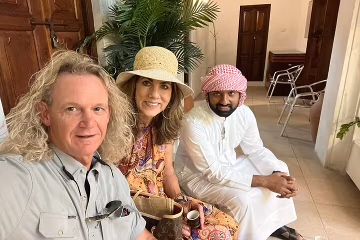 Travelers with Emirati guide in Al Fahidi, Old Dubai, during local food tastings and souk walking tour