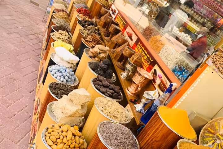 Spice souk display of herbs, dried fruits and nuts, part of Old Dubai food tasting and shopping walk