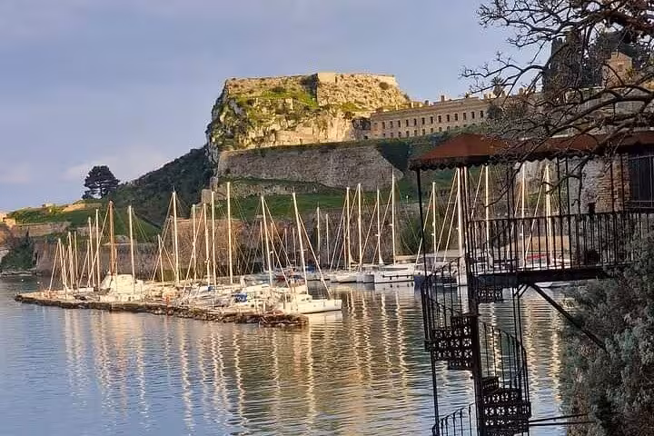 Old Fortress Corfu harbor with sailboats at sunset, highlight stop on Top 5 of Corfu guided tour