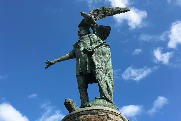 Bronze statue with eagle on head and outstretched arm against blue sky in Old Philadelphia