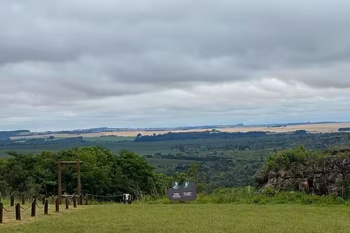 Expansive view of rolling hills and countryside from Old Town State Park's Hole of the Father under a cloudy sky.