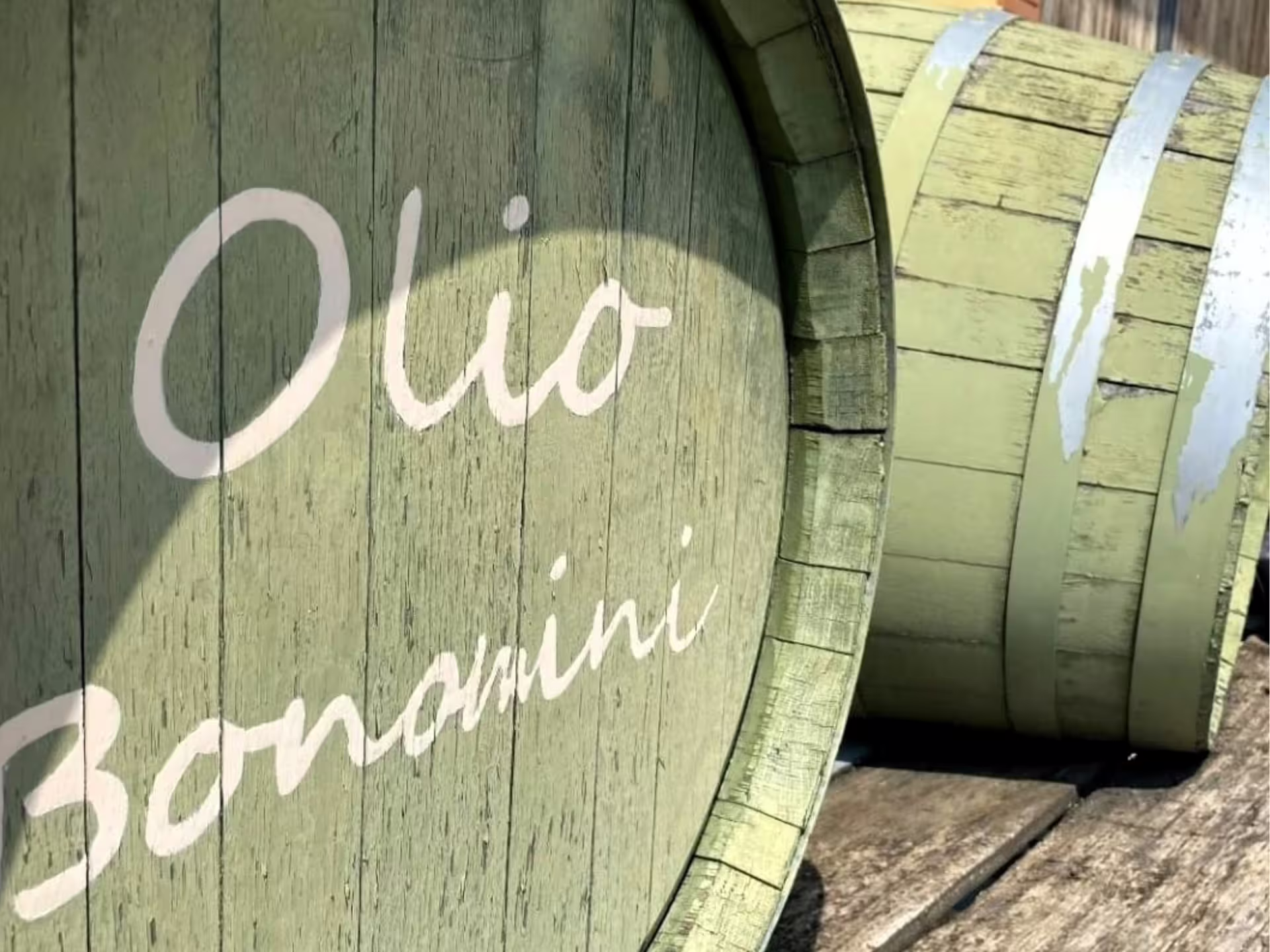Wooden barrel marked Olio Bonamini at Verona olive mill, symbol of extra virgin olive oil tasting tour