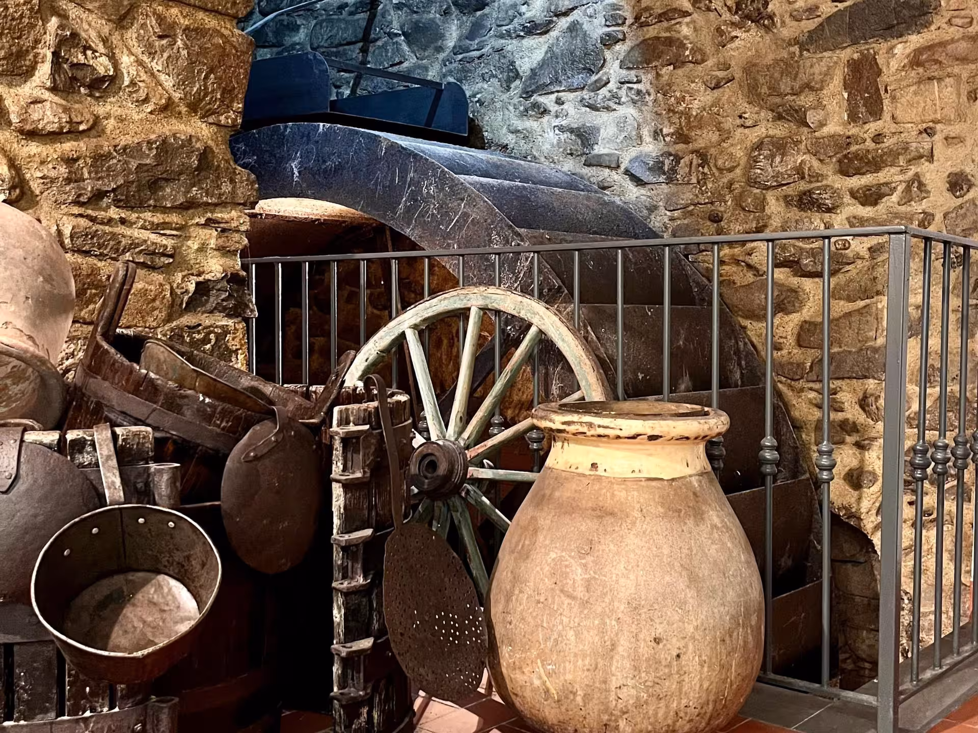 Historic olive mill equipment in Taggia showcasing traditional oil extraction methods for guided tastings.