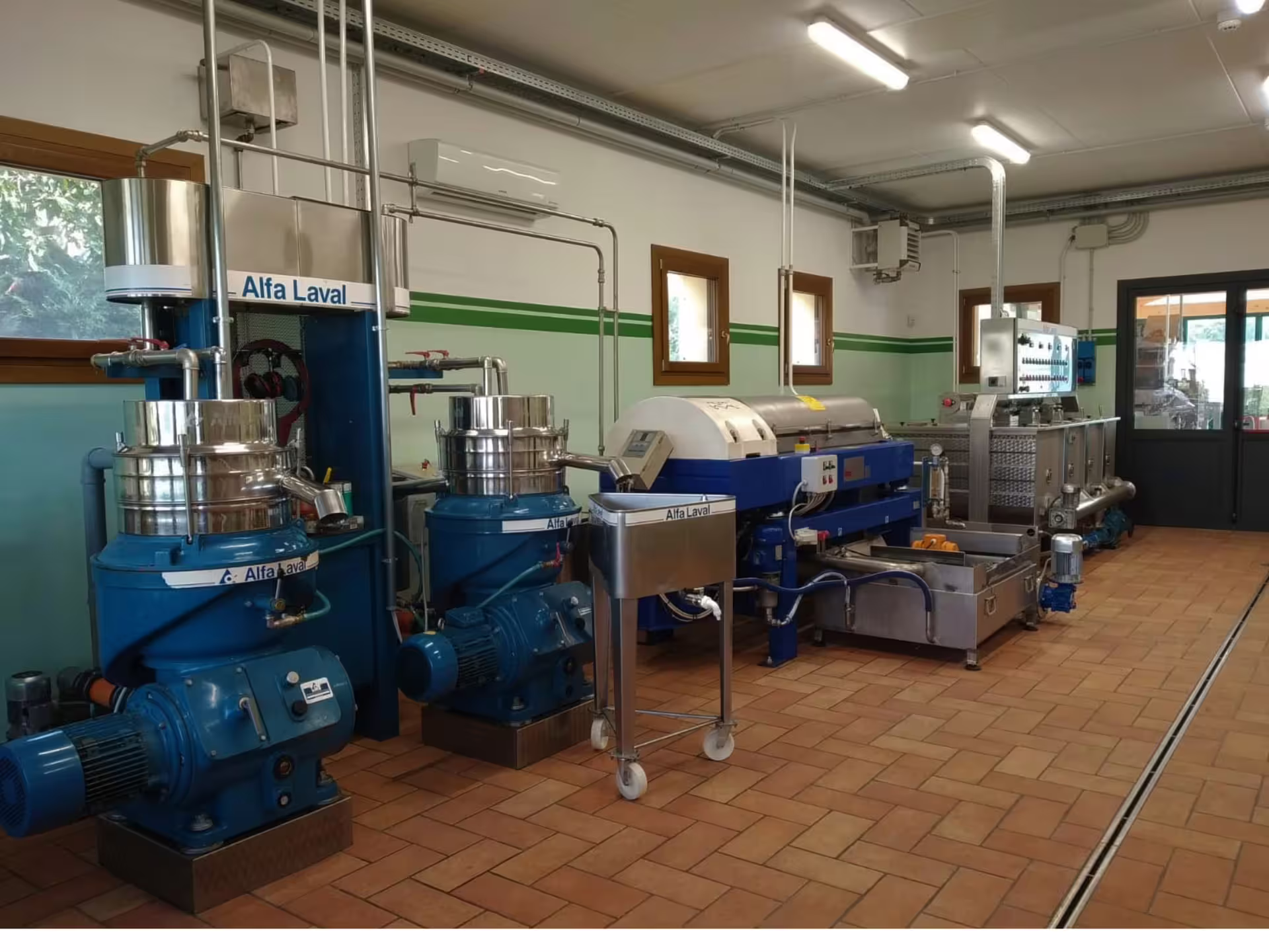Modern olive oil extraction room at a Padua Hills mill, showcasing production equipment on the olive mill tour and tasting