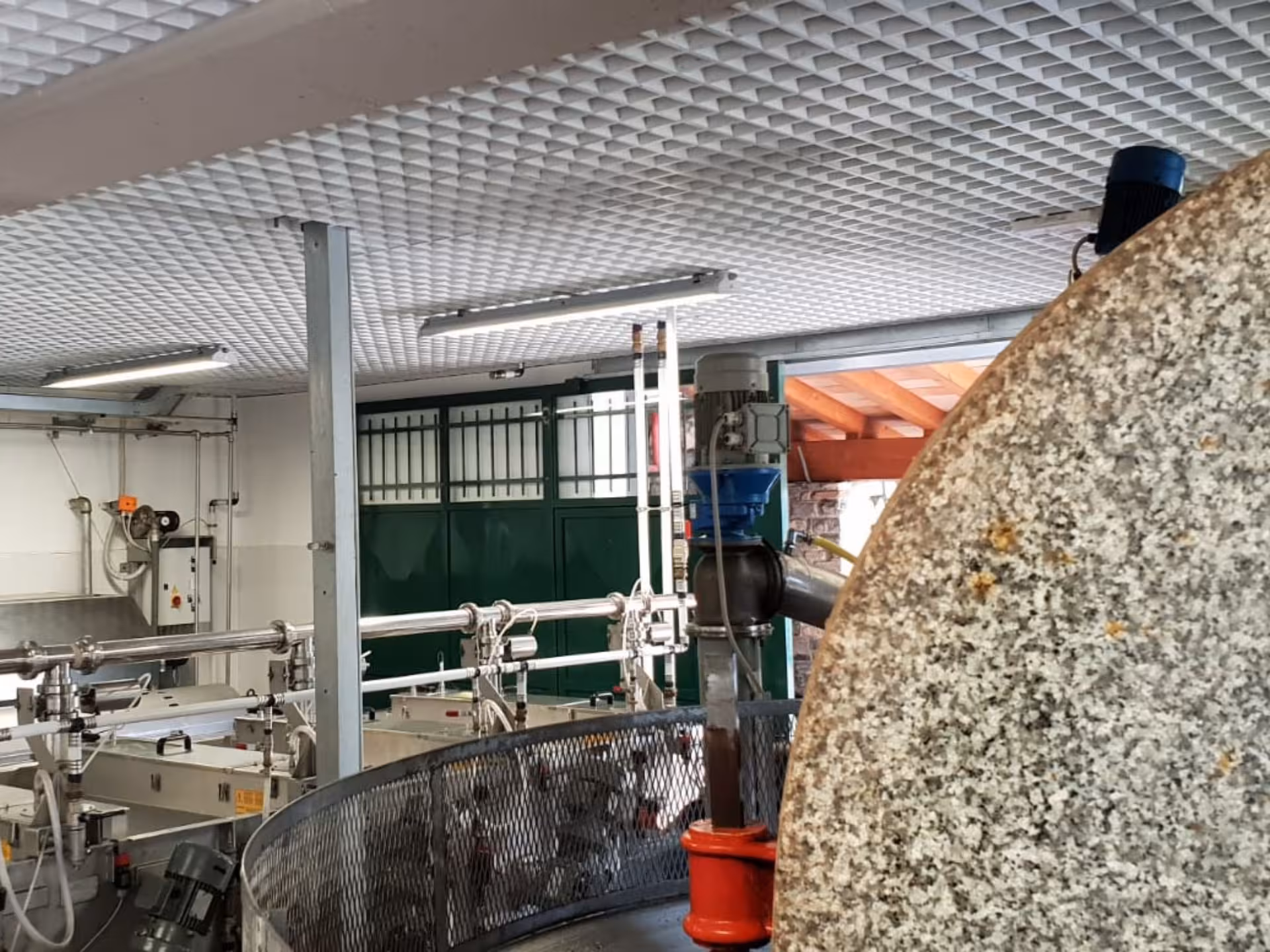 Modern olive mill machinery in Taggia, highlighting advanced equipment used in olive oil production tour.