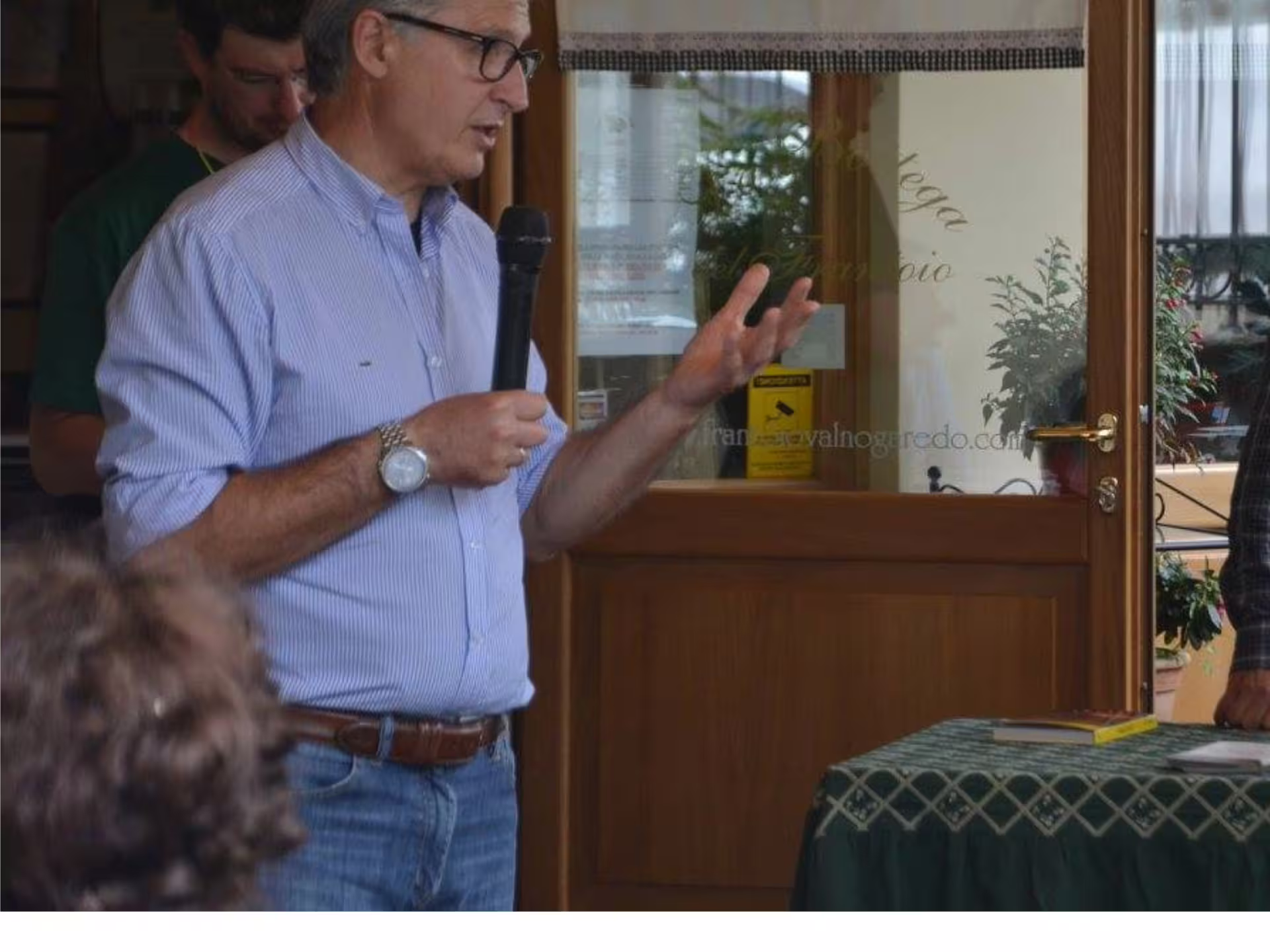 Guide explaining olive oil production during Padua Hills olive mill tour and tasting near Padua, Italy