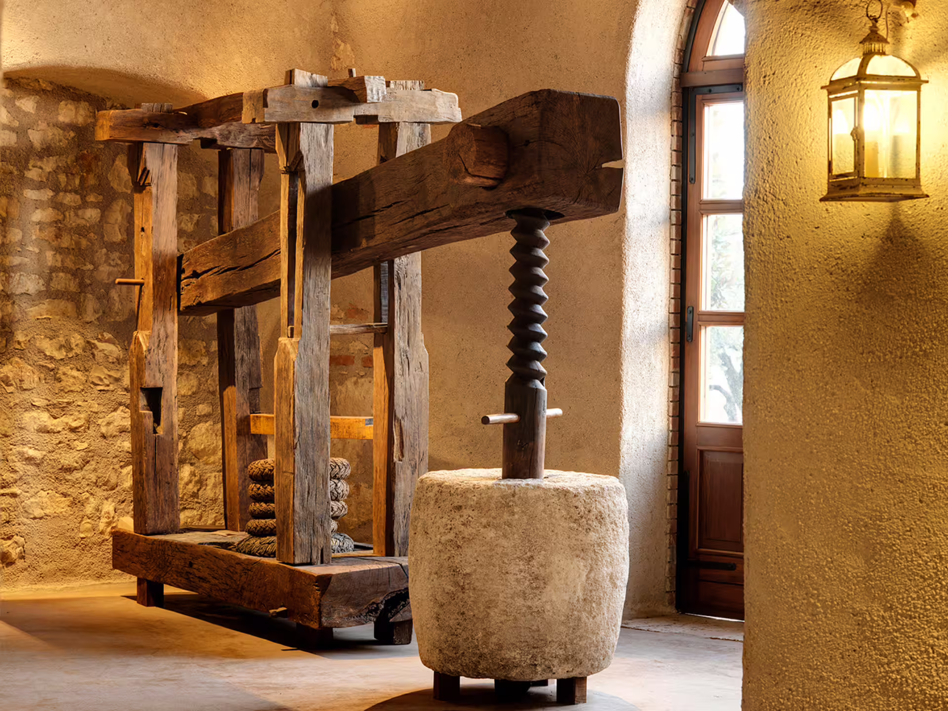 Historic wooden olive press inside a Verona countryside olive mill, featured on guided tour with olive oil tasting