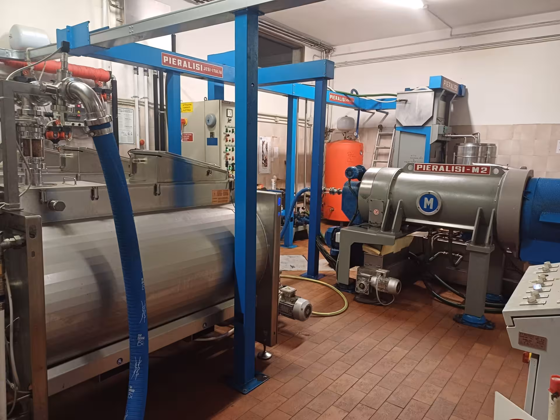 Modern olive oil extraction machinery in Chianciano showcasing advanced pressing technology for quality production.