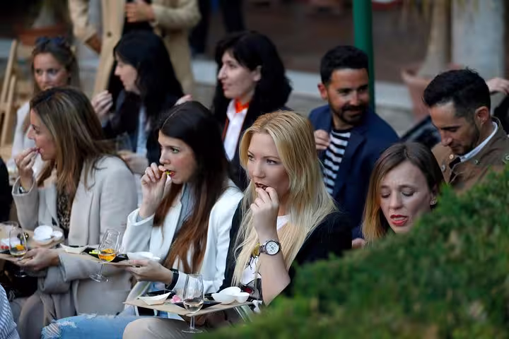 Group enjoying olive oil tasting breakfast outdoors in Cordoba, savoring unique flavors and gourmet selections.