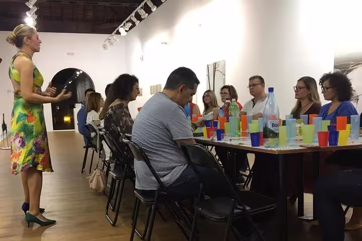 A lively group attending an olive oil tasting tour in Cordoba, guided by an expert in a bright, inviting setting.