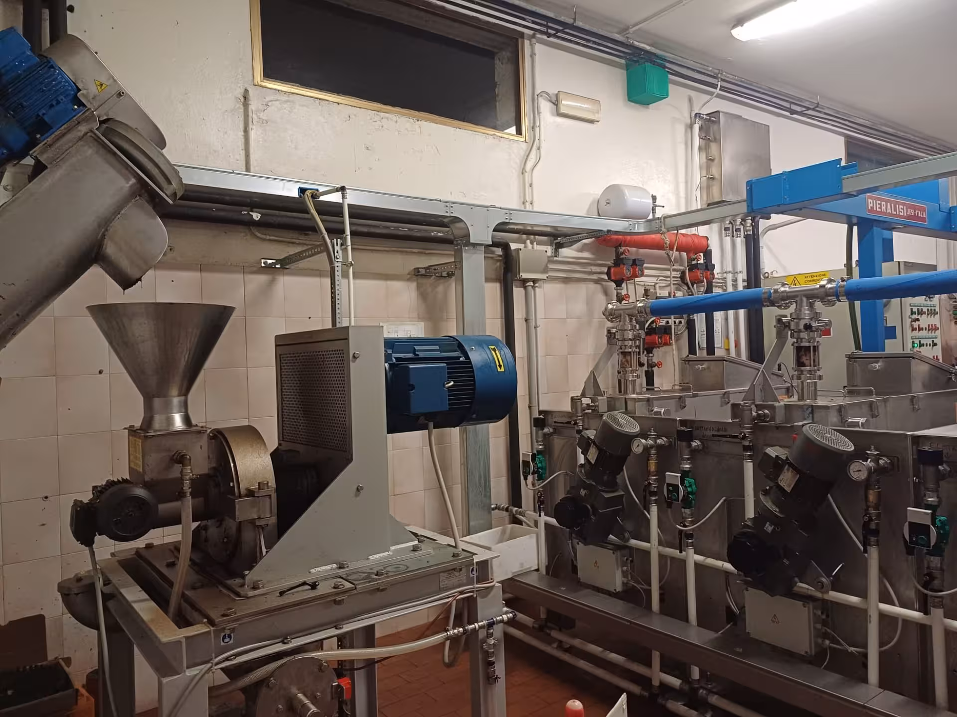 Sophisticated olive processing equipment in Chianciano, highlighting the mechanical precision of oil extraction.