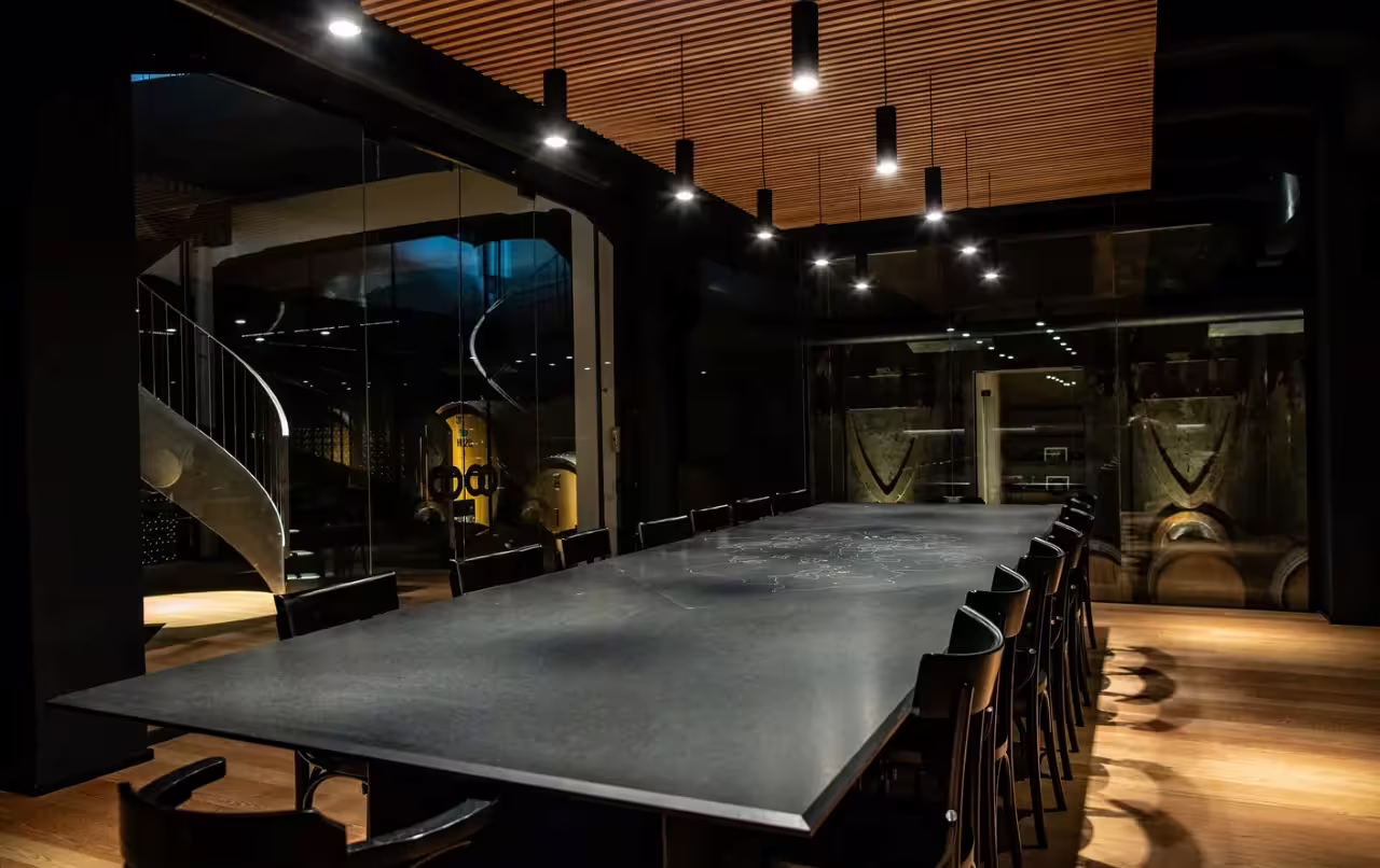 Modern Oltrepò Pavese winery tasting room with long table, perfect for guided wine tasting and winery tour